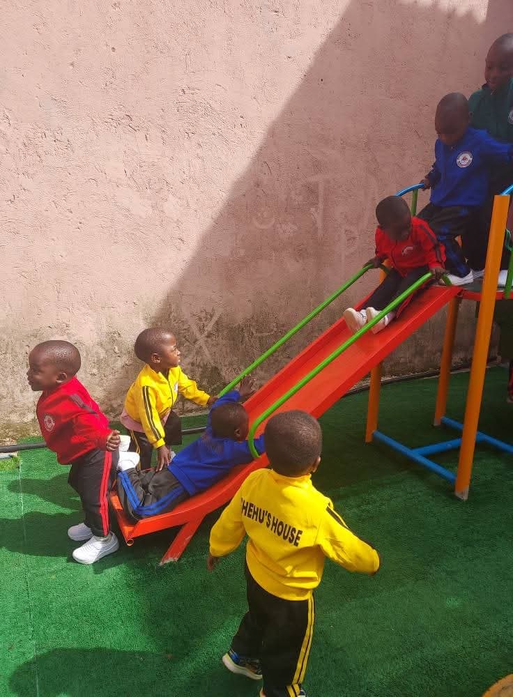 Toddlers playing with a swing